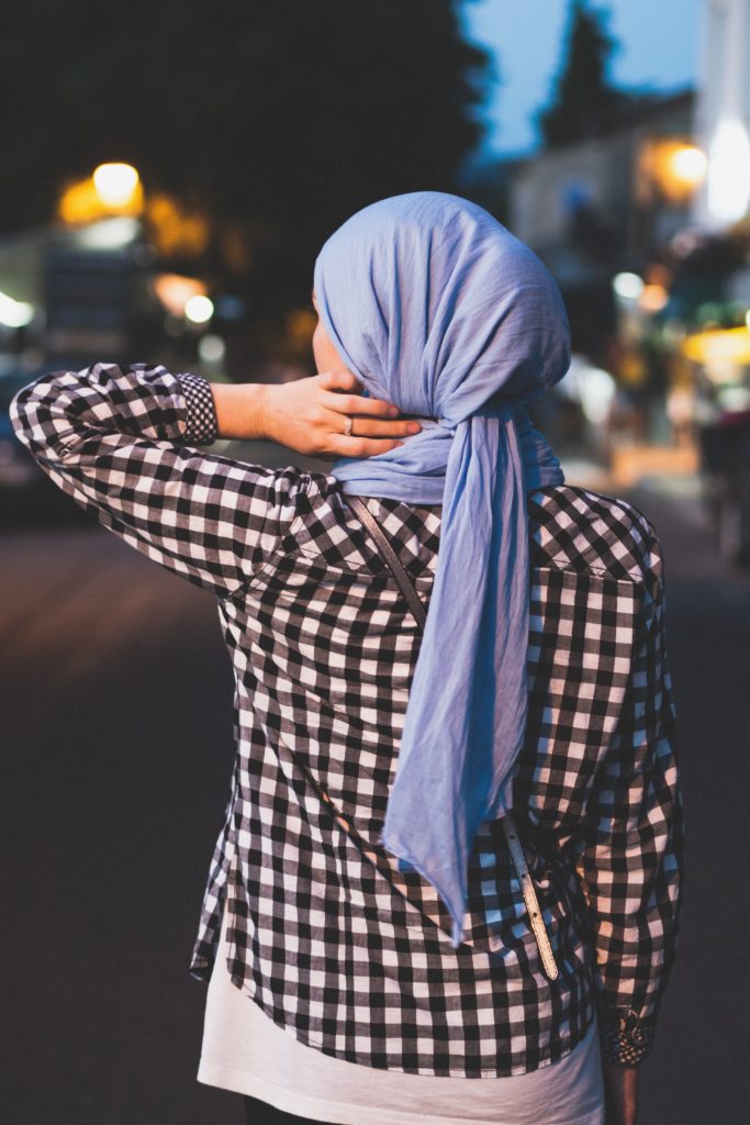 The back view of a woman wearing a headscarf